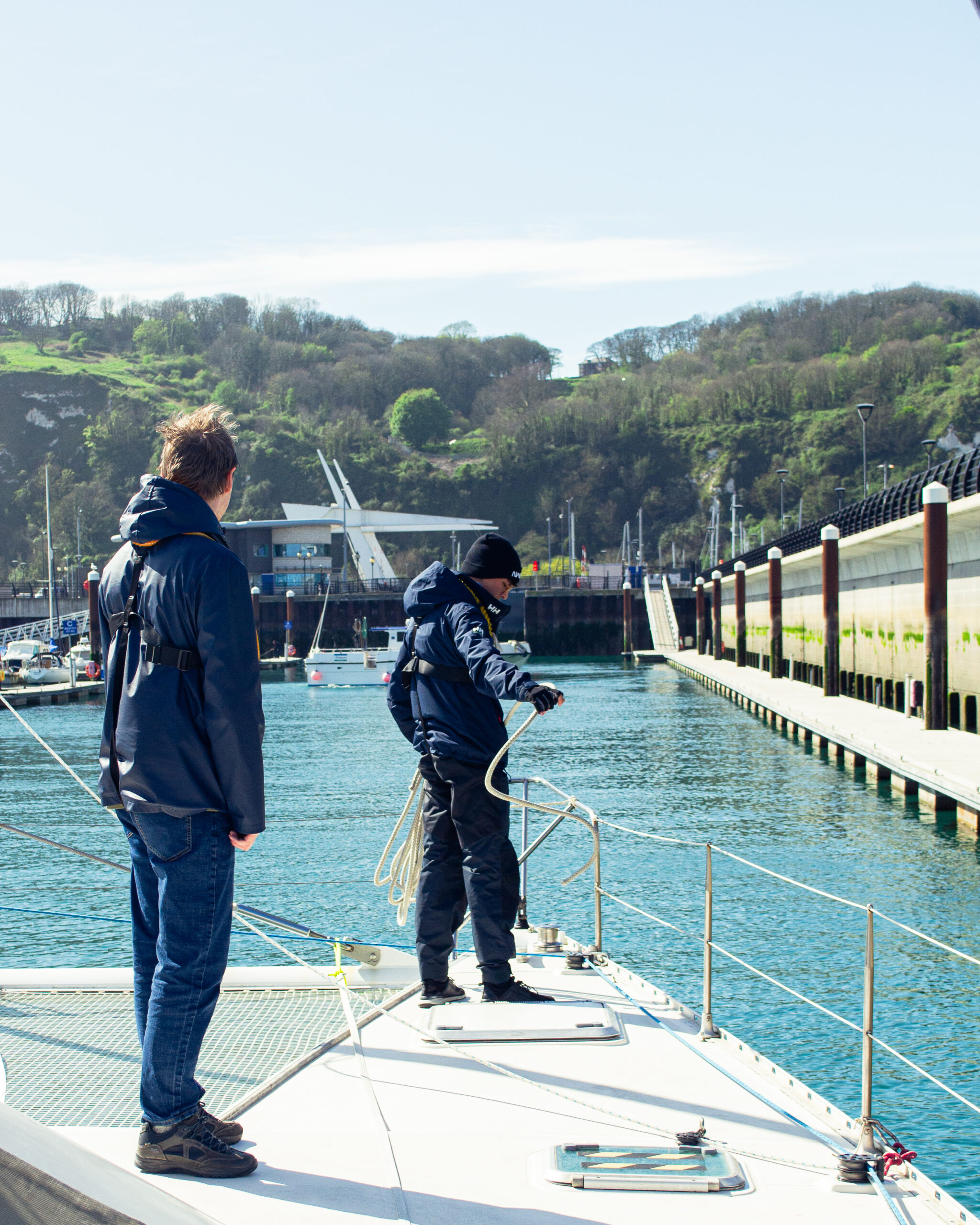 SailLink passengers arriving at a town-centre marina pontoon, steps from cafes and the station